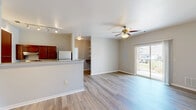 Located at 2770 Golden Currant View in Colorado Springs, CO, this two-bedroom, two-bathroom single-floor residence offers a well-designed, functional layout with a comfortable sense of space throughout. Light wood-style flooring runs continuously across the home, creating a cohesive and airy feel.

The open-concept kitchen and living area serves as the heart of the home. The kitchen features rich cherry wood cabinetry, granite-style countertops, stainless steel appliances including a refrigerator and range, and a peninsula breakfast bar that opens directly to the living area. Track lighting illuminates the kitchen, while the living room benefits from a ceiling fan and a sliding glass door that leads to a private balcony with outdoor views, allowing natural light to fill the space.

The primary bedroom is a generous size, offering a closet and direct access to its own bathroom. The second bedroom features a large window that brings in ample natural light. Both bathrooms are equipped with accessibility features including grab bars, granite-topped vanities, and wood-style flooring. A dedicated laundry room with an in-unit washer adds everyday convenience. Two closets and a hallway complete the practical and thoughtfully arranged floor plan.