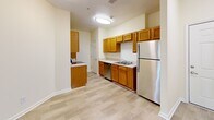Located at 3555 Sweetwater Rd in Duluth, GA, this two-bedroom, one-bathroom residence offers a well-organized single-floor layout designed for comfortable everyday living. The kitchen is fitted with warm honey-toned wood cabinetry, light countertops, and stainless steel appliances including a refrigerator, dishwasher, and range. Light wood-style flooring runs through the kitchen, which also benefits from a pantry for additional storage. The kitchen opens into a combined dining and living area, creating a cohesive, airy common space. Both bedrooms feature soft carpeting, ceiling fans, and windows that let in natural light with views of surrounding greenery. The primary bedroom is accessed through elegant French doors and includes a dedicated closet, while the second bedroom offers a similarly bright and comfortable feel with its own window. The full bathroom is clean and functional, featuring a vanity with a white countertop, a mirror, and tile-style flooring. Additional conveniences include a laundry area, a utility room, and a private balcony—ideal for enjoying the outdoors. Two closets provide ample storage throughout the home, rounding out this practical and inviting residence.