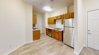 Located at 3555 Sweetwater Rd in Duluth, GA, this two-bedroom, one-bathroom residence offers a well-organized single-floor layout designed for comfortable everyday living. The kitchen is fitted with warm honey-toned wood cabinetry, light countertops, and stainless steel appliances including a refrigerator, dishwasher, and range. Light wood-style flooring runs through the kitchen, which also benefits from a pantry for additional storage. The kitchen opens into a combined dining and living area, creating a cohesive, airy common space. Both bedrooms feature soft carpeting, ceiling fans, and windows that let in natural light with views of surrounding greenery. The primary bedroom is accessed through elegant French doors and includes a dedicated closet, while the second bedroom offers a similarly bright and comfortable feel with its own window. The full bathroom is clean and functional, featuring a vanity with a white countertop, a mirror, and tile-style flooring. Additional conveniences include a laundry area, a utility room, and a private balcony—ideal for enjoying the outdoors. Two closets provide ample storage throughout the home, rounding out this practical and inviting residence.