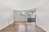 Located at 650 Ebbcreek Drive in Corona, California, this one-bedroom, two-bathroom residence offers a thoughtfully organized single-floor layout designed to maximize comfort and functionality. Warm wood-look flooring flows throughout the main living areas, complemented by neutral beige walls and textured ceilings that give the space a clean, consistent aesthetic.

The living room is a bright and open area, featuring a sliding glass door that opens to an outdoor patio, alongside an additional window that fills the room with natural light and views of surrounding greenery. The kitchen is well-appointed with white cabinetry, light quartz countertops, and a full suite of stainless steel appliances, including a range, dishwasher, and refrigerator, making it both practical and visually appealing.

The bedroom is a comfortable retreat finished with plush carpeting, a window for natural light, and access to a dedicated closet. A connecting hallway leads to the two bathrooms, one of which features a white vanity with mirror and a clean tub surround. Throughout the unit, crisp white trim and doors add a polished finish. This efficiently designed residence offers a well-balanced living experience in a convenient Corona location.