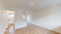 Located at 1725 Park Ave in the vibrant Silver Lake neighborhood of Los Angeles, this thoughtfully updated single-floor unit showcases a clean, modern aesthetic throughout. Light wood-tone flooring runs seamlessly across the entire space, creating a warm and cohesive feel.

The open living area features crisp white walls, recessed lighting, and a pass-through opening to the kitchen, fostering a connected and airy atmosphere. The kitchen is well-appointed with white shaker cabinetry, sleek quartz countertops, a matte black undermount sink with a matching pull-down faucet, stainless steel gas range, refrigerator, and dishwasher. Floating wood shelves add a contemporary design touch, while a window brings in natural light.

The bedroom offers a comfortable layout with a sliding-door closet, a wall-mounted AC unit, and a window overlooking the surrounding neighborhood. An additional room with natural light and a built-in closet provides flexible living options.

The bathroom is finished in clean white subway tile surrounding a soaking tub and shower combination, complemented by matte black hardware and a warm wood-toned vanity, lending a modern yet inviting character to the space.