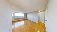Located at 3400 Weston Rd in Toronto's Humber Summit neighbourhood, this well-proportioned one-bedroom, one-bathroom unit offers a practical and comfortable layout across a single floor. Warm parquet flooring flows throughout the living spaces, adding a classic character to the interior. The living room is generously sized, bathed in natural light through large windows that frame open outdoor views of the surrounding cityscape — an inviting space well-suited for both relaxing and entertaining. An opening in the living area connects seamlessly to the kitchen, which features white cabinetry and includes essential appliances. The spacious primary bedroom offers ample room, a double-door closet for storage, and its own window bringing in natural light. Neutral grey walls throughout provide a clean, versatile backdrop. The bathroom is finished with white subway tile surrounding a full soaker tub with an overhead shower and chrome fixtures, offering a bright, functional space. A textured ceiling and baseboard heating are consistent features throughout the unit. The layout is efficient and well-organized, making excellent use of the available space while maintaining a comfortable, livable atmosphere.