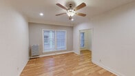 Located on N Edgemont Street in the desirable Los Feliz neighborhood of Los Angeles, this single-floor unit offers a clean, functional layout with consistent hardwood flooring throughout every room, lending warmth and continuity to the entire space.

The main living area is bright and open, benefiting from multiple windows fitted with blinds that allow natural light to filter in. A ceiling fan with integrated lighting is centrally positioned overhead, enhancing airflow and comfort. The room connects directly to an adjacent space, creating an easy, open flow between living areas.

The bedroom is generously proportioned and includes a ceiling fan, a built-in closet, and a charming arched doorway that leads to additional storage. The room is bathed in natural light and provides direct access to the bathroom, adding a practical touch to the layout.

The bathroom is neatly appointed with a pedestal sink, a wall-mounted mirror, a bathtub, and wood-look tile flooring, maintaining a clean and classic aesthetic.

The kitchen is a galley-style space featuring white appliances, including a gas range and refrigerator, open shelving for storage, and hardwood flooring that ties seamlessly into the rest of the home.

An additional room with a window and ceiling fan offers flexibility for use as a second bedroom, office, or flex space. Throughout the unit, the neutral color palette and consistent finishes create a cohesive, move-in ready environment.