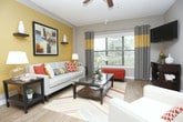 Located at 3385 Atlanta Rd SE in Smyrna, Georgia, this single-floor residence offers a thoughtfully designed layout with a welcoming open-concept living and dining area. The living room features warm wood-look flooring, large windows that invite natural light, a ceiling fan, and a neutral color palette accented by bold wall tones, creating a comfortable and stylish atmosphere.

The galley-style kitchen is well-equipped with granite countertops, white cabinetry, a mosaic tile backsplash, stainless steel appliances including a range and microwave, and a convenient breakfast bar with seating — connecting seamlessly to the living area.

The bedrooms offer plush carpeting, ceiling fans, and striking accent walls in deep navy and charcoal tones that add character to each room. Windows allow for natural light and outdoor views, enhancing the restful ambiance. Each bedroom provides ample space for comfortable furnishings.

The bathroom includes a full tub-shower combination with tile surround and wood-look flooring, maintaining the cohesive design aesthetic found throughout the home. Overall, the residence presents a modern, well-coordinated interior with practical features and a warm, livable character suited for everyday comfort.