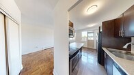 Located on the third floor at 3890 Bathurst Street in Toronto's vibrant North York neighbourhood, this one-bedroom, one-bathroom unit offers a well-designed layout making efficient use of its compact footprint. The kitchen is a standout feature, equipped with stainless steel appliances including a full-size refrigerator, dishwasher, and range. Rich dark wood cabinetry lines the walls and is complemented by a peninsula with a light-toned countertop, providing additional prep space and a natural divide between the kitchen and living area. Light-toned tile flooring grounds the kitchen zone, while warm parquet wood flooring flows throughout the rest of the unit, adding character and continuity. The bedroom is a comfortable size, featuring a sliding-door closet for ample storage and the same distinctive parquet flooring. A window allows natural light to fill the room. The bathroom is finished with neutral large-format wall tiles surrounding a full soaking tub and shower, creating a clean and calming aesthetic. A private balcony with a glass railing offers open views of the surrounding neighbourhood and greenery. The unit presents a practical and attractive living space in a well-established Toronto location.