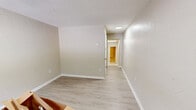 Located at 2215 Buffalo Trail in Morristown, Tennessee, this single-story, one-bedroom, one-bathroom unit offers an efficient and practical layout across its single floor. The living room greets residents at entry, featuring light wood-look laminate flooring, neutral textured walls, a textured ceiling, and a window that brings in natural light and a view of the surrounding neighborhood. A hallway connects the main living area to the private rooms, maintaining a straightforward and functional flow throughout. The kitchen is equipped with white cabinetry, granite-style countertops, an under-cabinet range hood, and a single-basin sink, all set atop classic white tile flooring — providing a clean and utilitarian cooking space. The bedroom offers a comfortable footprint with tile flooring and a dedicated closet featuring bifold doors for convenient storage. The bathroom includes a full tub and shower combination with white subway tile surround, a medicine cabinet mirror, and a pedestal sink. Additional utility space is provided by a separate utility room, adding practical functionality to the unit's layout. Throughout the home, neutral tones, white trim, and consistent flooring choices create a cohesive and understated aesthetic well-suited for comfortable everyday living.