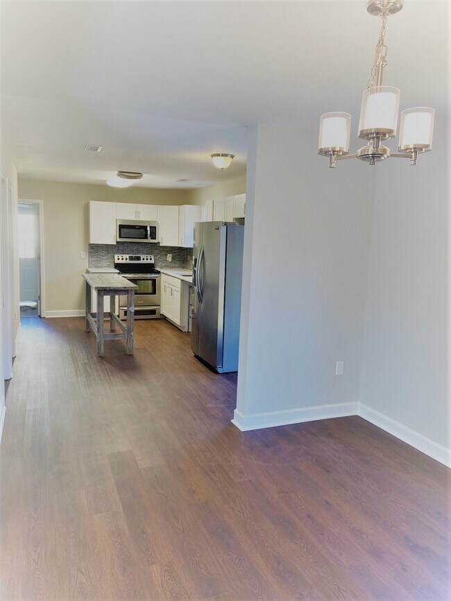 Plank flooring throughout downstairs - 5939 Bluebonnet Rd