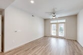 Located in Atlanta's vibrant Old Fourth Ward neighborhood, this well-appointed 2-bedroom, 2-bathroom residence offers a thoughtfully designed single-level layout with modern finishes throughout. Light-toned hardwood-style flooring flows seamlessly across all living areas, creating a cohesive and airy feel.

The open-concept living room is bright and welcoming, featuring a ceiling fan, recessed lighting, and French doors that invite natural light and provide outdoor access. It connects naturally to the kitchen, which serves as a functional centerpiece of the home. The kitchen is outfitted with slate-gray cabinetry, a marble-look quartz countertop with a peninsula, stainless steel appliances including a refrigerator, range, microwave, and dishwasher, and stylish pendant lighting overhead.

Both bedrooms are comfortably sized, each featuring ceiling fans, neutral walls, and dedicated closets with built-in shelving. The primary bedroom includes natural light from dual windows. Each of the two bathrooms mirrors the home's modern aesthetic, with gray vanity cabinetry, quartz countertops, a framed mirror, and a tub-shower combination with tile surround. The layout is completed by two hallways and two closets, providing practical storage and smooth circulation throughout the residence.