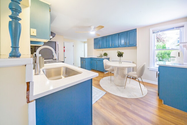 Kitchen with brand new stone countertops, sink & faucet - digitally staged - 47 Pitkin St House
