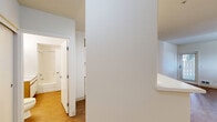 Located at 840 C St in San Rafael, CA, this one-bedroom, one-bathroom unit offers a thoughtfully organized single-floor layout that makes efficient use of its space. The living room features warm wood-look flooring, crisp white walls, and a window that invites natural light and views of surrounding greenery. A pendant light fixture adds a functional accent to the area, contributing to its clean, understated aesthetic.

The bedroom is carpeted for comfort and includes a closet and a window that brings in additional natural light. Its neutral tones and simple design provide a versatile canvas for personalization.

A hallway connects the main living areas to the full bathroom, which is finished with the same warm wood-look flooring found throughout the unit. The bathroom features a vanity with cabinet storage, a large mirror with overhead lighting, and a toilet — all maintained in a clean, bright, and functional layout.

Throughout the unit, consistent use of white walls and light flooring creates a cohesive and airy feel. The layout flows logically from the entry through the living area, bedroom, and bath, making practical use of every square foot. This unit is situated in San Rafael, a city in Marin County with convenient access to local amenities and transit.