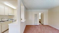 Located at 3725 Garnet St in Torrance, CA, this single-floor, one-bedroom, one-bathroom unit offers a practical and well-organized layout. The living room greets you with soft carpeted flooring, a textured ceiling, and two windows that allow natural light to fill the space, offering views of the surrounding exterior. A pass-through counter connects the living area to the galley-style kitchen, which features white cabinetry extending to the ceiling, a gas range, a double sink, a full-size refrigerator, and light wood-look flooring — providing efficient use of the available space. The bedroom is a comfortable, carpeted retreat with a natural window fitted with vertical blinds, and a full-width mirrored sliding closet that enhances the sense of space while providing ample storage. The bathroom is cleanly finished with a single-sink vanity topped in white, framed mirrors, and a glass-door shower and tub combination, with wood-look flooring that ties the space together. Throughout the unit, neutral warm tones, white trim, and a consistent textured ceiling treatment contribute to a cohesive and understated aesthetic well-suited for comfortable single-occupant living in the South Bay area of Los Angeles County.