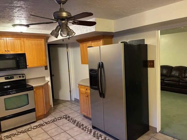 Refrigerator, range, and microwave. - 4220 S Lynne Ln