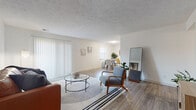 Located on Chenal Parkway in Little Rock, Arkansas, this single-floor residence offers a well-organized layout designed for comfortable, everyday living. The open-concept living and dining area is bright and welcoming, featuring light wood-look flooring, a textured ceiling, and large vertical-blind-covered windows that allow generous natural light to fill the space. A fireplace anchors one end of the living area, adding a functional focal point to the room.

The kitchen is thoughtfully updated with white cabinetry, granite countertops, a classic subway tile backsplash, and stainless steel appliances. A breakfast bar provides additional seating and connects the kitchen to the adjacent dining area, making the space practical for both everyday meals and entertaining.

The two bedrooms are carpeted and include ceiling fans and windows with blinds, offering a comfortable, quiet retreat. Each room provides ample space for furnishings. A versatile secondary room with carpet and a ceiling fan functions well as a home office or additional bedroom.

Two bathrooms serve the unit — one featuring a shower-tub combination with clean white finishes, and the other with a standalone glass-enclosed shower. Both bathrooms include wood-look flooring and granite vanity surfaces, maintaining a consistent, cohesive aesthetic throughout the home.