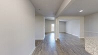 Located at 14231 FM-1464 N in Sugar Land, TX, this single-story 2-bedroom, 2-bathroom home offers a thoughtfully designed layout across a comfortable footprint. The open living and dining areas are finished with durable wood-look flooring in a neutral gray tone, complemented by crisp white trim and a textured ceiling. Large windows allow natural light to filter through, creating a bright and welcoming atmosphere throughout the main living spaces.

The kitchen features granite countertops, white cabinetry, and a breakfast bar, flowing seamlessly into the dining area. Both bedrooms are carpeted and include ceiling fans with light fixtures, individual closets, and ample wall space. The generously sized primary bedroom offers a walk-in closet with wire shelving for organized storage. The bathrooms are well-appointed, with one featuring a soaking tub, granite vanity countertops, and wood-look tile flooring.

Additional highlights include a dedicated laundry room with a full-size washer and dryer, five closets throughout for exceptional storage, and a private patio for outdoor enjoyment. The home's neutral color palette, consistent finishes, and functional room arrangement make it a practical and comfortable residence in the Sugar Land area.