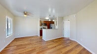Located at 1379 27th St in San Diego, CA, this single-floor residence offers a well-designed layout that balances comfort and functionality. The open-concept living and dining area is finished with warm hardwood-style flooring that flows throughout the main living spaces, creating a cohesive and inviting atmosphere. Ceiling fans are present in multiple rooms, providing year-round comfort.

The kitchen is a standout feature, showcasing rich dark wood cabinetry, granite-style countertops, and a full suite of stainless steel appliances including a refrigerator, electric range, and over-the-range microwave. A peninsula with pendant lighting serves as a natural divider between the kitchen and the living area, offering additional prep space and a casual seating opportunity.

The bedroom is carpeted for added warmth and comfort, with a ceiling fan overhead and a window that allows natural light and outdoor views. Additional rooms feature hardwood-style flooring, neutral wall tones, and windows fitted with blinds. The bathroom is outfitted with a full tub-and-shower combination featuring brushed nickel fixtures. Throughout the unit, clean white trim and soft neutral wall colors create a bright, move-in-ready environment.