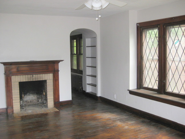 Living room, fireplace, archway to dining room - Kenmore Estates Apartments