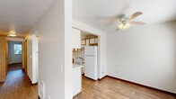 Located at 2404 Allen St. in Kelso, WA, this single-floor, one-bedroom, one-bathroom unit offers a practical and well-organized layout. The living room is bright and open, featuring rich wood-look flooring, crisp white walls, and a sliding glass door fitted with vertical blinds that leads directly to a private patio, allowing natural light to flow in and providing outdoor access. A ceiling fan with light fixture in the dining area adds comfort and functionality to the shared living and dining space.

The kitchen is efficiently designed with white cabinetry trimmed in warm wood tones, a breakfast bar peninsula, a full suite of white appliances including a refrigerator, stove, and dishwasher, and a window that brings in additional natural light. The layout connects seamlessly to the dining area for easy everyday use. A dedicated laundry area and multiple closets throughout add valuable storage and convenience.

The bedroom offers a comfortable, carpeted retreat with a natural light window and a spacious closet with built-in rod and shelf. The full bathroom includes a wide vanity with ample counter space, gold-accented cabinetry, a mirrored medicine cabinet, and a tub-shower combination, all finished with wood-look flooring consistent with the rest of the home.