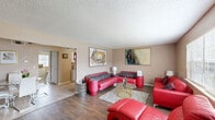 Located at 2814 SW 59th St in Oklahoma City, Oklahoma, this single-story home offers a functional and comfortable layout across two bedrooms, one bathroom, and a connected living and dining area. The living room is a generous, open space featuring rich hardwood-style flooring, a textured ceiling, and multiple windows that allow natural light to fill the room. The space flows seamlessly into a dedicated dining area, making it ideal for both relaxing and entertaining. A hallway connects the main living areas to the private quarters of the home. The primary bedroom is a well-proportioned retreat with plush carpeting, a large window overlooking the outdoors, and access to a walk-in closet complete with built-in shelving rods for organized storage. The second bedroom also features carpet flooring, a window with natural light, and its own closet space. The bathroom is clean and functional, offering a wide vanity with white cabinetry, an integrated sink, a framed mirror, and tile flooring. Warm, neutral tones carry throughout the home, creating a cohesive and welcoming ambiance. This residence offers a practical and comfortable living experience in a convenient Oklahoma City location.