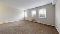 Located at 480 Main St in West Haven, Connecticut, this efficiently designed single-floor unit offers a thoughtful layout that maximizes comfort and functionality. The combined living and dining area is bright and welcoming, featuring wall-to-wall carpeting, neutral-toned walls, and multiple windows that allow natural light to fill the space. A baseboard heating unit and wall-mounted AC unit ensure year-round comfort, while the windows offer pleasant views of the surrounding neighborhood.

The kitchen is compact yet well-equipped, showcasing white cabinetry with brushed nickel hardware, rich dark marble-style countertops, tile flooring, and a white electric range with overhead ventilation — a clean and practical space for everyday cooking.

The bathroom is finished in a crisp, all-white palette with classic square tile surrounding a full soaking tub and shower combination, complemented by tile flooring for a clean, timeless look.

Throughout the unit, four closets provide generous storage solutions, helping to keep the space organized and clutter-free. A hallway connects the various areas of the unit seamlessly. The overall ambiance is clean, neutral, and move-in ready, making it a practical and comfortable home in West Haven.