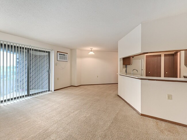 Living Room with Large Sliding Glass Door - Rivers Edge Apartments