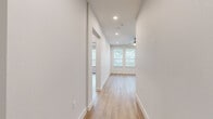 Located at 11464 Alamo Ranch Pkwy in San Antonio, TX, this well-appointed 2-bedroom, 2-bathroom home offers a thoughtfully designed single-level layout. The open-concept living, dining, and kitchen area is bright and welcoming, featuring light wood-style flooring, recessed lighting, and ceiling fans throughout. Large windows dressed with blinds invite generous natural light into every room.

The kitchen is a standout feature, showcasing flat-front light wood cabinetry, crisp white quartz countertops, a farmhouse sink, white subway tile backsplash with under-cabinet lighting, stainless steel appliances, and a central island illuminated by two stylish pendant lights. The space flows seamlessly into the dining and living areas, making it ideal for entertaining.

The primary bedroom is generously sized, complete with a ceiling fan and en-suite bathroom. The primary bath features a long wood-toned vanity with dual sinks, a glass-enclosed shower, and direct access to a walk-in closet with built-in shelving. The second bedroom is well-proportioned with ample natural light. Additional highlights include multiple closets, a dedicated laundry area, a utility room, and a private balcony. Clean, modern finishes give the space a fresh and contemporary feel throughout.