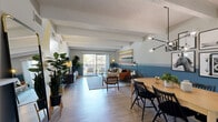 Located at 10050 E Harvard Ave in Denver, CO, this well-appointed one-bedroom, one-bathroom residence offers a thoughtfully designed layout across a single floor. The open-concept living, dining, and kitchen area serves as the heart of the home, characterized by light wood-style flooring, exposed ceiling beams, and a striking two-tone blue and neutral wall palette that lends a modern, mid-century feel throughout. The living room is bright and inviting, anchored by a sliding glass door that opens to a private balcony overlooking lush greenery. The dining area features a contemporary multi-globe chandelier, adding an artistic focal point above the wooden dining table. The kitchen is efficiently designed with dark cabinetry, stainless steel appliances, a tile backsplash, light quartz countertops, and a peninsula with bold geometric color-blocked detailing that connects seamlessly to the dining space. The bedroom continues the cohesive design language with exposed beams, a soft color palette, and its own sliding glass door to a private outdoor space. A dedicated closet and a full bathroom with wood-look flooring complete the layout. A hallway connects all areas cleanly, maximizing the functional use of the well-proportioned floor plan.