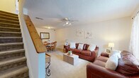 Located in the Castlewood community of Charleston, SC, this two-story, 2-bedroom, 2-bathroom home offers a practical and comfortable layout spread across two well-proportioned floors. The main level features a combined living and dining area with plush carpeting, a ceiling fan with light fixture, and windows that bring in natural light. The galley-style kitchen is equipped with warm oak cabinetry, white appliances including an electric range and refrigerator, and a built-in breakfast bar with seating — ideal for casual dining. A dedicated laundry room with full-size washer and dryer hookups and overhead storage adds everyday convenience. Upstairs, the spacious primary bedroom is generously sized and connects to a bathroom featuring a dual-sink vanity, offering a comfortable private retreat. The second bedroom is bright and carpeted, with a window overlooking the exterior. A second full bathroom with a tub-shower combination serves the additional bedroom. Three closets throughout the home provide ample storage. With a textured ceiling throughout and a clean, neutral palette, this home presents a welcoming and functional living environment in a well-established Charleston neighborhood.