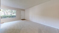 This 570 square foot apartment in Fullerton, California, offers a practical living space with two bedrooms and one bathroom. The layout maximizes functionality within its compact footprint, with the primary bedroom being notably spacious at 330 square feet. The living areas feature neutral-toned walls and plush wall-to-wall carpeting, creating a bright and inviting atmosphere. Large windows in the main living space and bedrooms allow ample natural light, enhancing the sense of openness. The apartment is equipped with a wall-mounted air conditioning unit for climate control. The bathroom showcases a modern design with a white vanity, granite countertop, and a shower-tub combination. Light wood-look flooring in the bathroom adds warmth to the space. The apartment's single-story layout and efficient design make it an ideal choice for those seeking a cozy yet comfortable living environment in a convenient Fullerton location.
