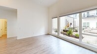 Located at 1517 H Street in the heart of downtown Sacramento, this single-level residence features two bedrooms and two bathrooms within a thoughtfully designed floor plan. The open living and kitchen area serves as the social hub of the home, finished with light wood-style flooring and soaring ceilings that amplify the sense of space. The contemporary kitchen is equipped with stainless steel appliances, including a French door refrigerator and range, complemented by two-tone cabinetry in white and warm wood tones, and a subway tile backsplash. Large sliding glass doors and oversized windows flood the living areas with natural light while offering views of a resort-style pool and outdoor lounge area. The bedrooms are carpeted for comfort, each featuring sliding glass doors or windows that invite in natural light and neighborhood views. The primary bedroom includes a spacious closet with a sliding door and built-in rod and shelving. Both bathrooms are appointed with elegant marble-style tile surrounds in the tub-shower combinations and wood-look flooring, adding a refined touch. A hallway and dedicated closet provide practical storage throughout. The clean, neutral palette and modern finishes create a bright, cohesive aesthetic throughout the residence.