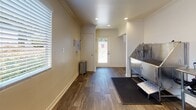 Located at 7400 Parkway Dr in La Mesa, California, this single-floor commercial pet grooming facility is purpose-built for professional pet care services. The space is thoughtfully designed with functionality and cleanliness in mind, featuring durable hardwood-style flooring throughout that is both easy to maintain and visually appealing.

The grooming area serves as the centerpiece of the facility, equipped with multiple professional-grade stainless steel grooming tubs fitted with built-in spray attachments and step platforms for easy pet access. A centrally positioned stainless steel utility table provides a practical workspace for grooming tools and supplies, while a wall-mounted paper towel dispenser adds convenience. Anti-fatigue rubber mats are positioned at each tub station to ensure safety and comfort during use.

Natural light filters in through shuttered windows, lending a bright and welcoming atmosphere to the space. Crown molding details and recessed lighting contribute a clean, polished aesthetic throughout. The layout also includes a dedicated utility area with built-in wall outlets and plumbing rough-ins, offering infrastructure for additional equipment. A clearly marked fire extinguisher and no-smoking signage reflect a commitment to safety standards. The overall environment is efficiently organized, hygienic, and well-suited for a professional pet grooming operation.