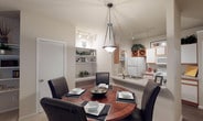 This single-story residence in Cedar Hill, Texas offers a well-designed, functional layout with a warm and inviting ambiance throughout. The open-concept dining area seamlessly connects to the kitchen, where wood-toned cabinetry with white accents, a full suite of appliances, wood-look flooring, and a peninsula counter create a practical and appealing space for cooking and entertaining. A built-in wine rack and open shelving add character to the kitchen's design. Adjacent to the kitchen, a dedicated dining nook features built-in shelving, ideal for displaying décor. The living room is generously sized, showcasing vaulted ceilings, a ceiling fan, built-in shelving alcoves, and a sliding glass door that fills the room with natural light and provides outdoor access. The bedrooms are well-proportioned, with one featuring an arched window that invites additional natural light, plush carpeting, and a walk-in closet. The bathroom is finished with wood-look flooring, a wide vanity with ample counter space, a large mirror, and a full tub-shower combination with tile surround. Throughout the home, neutral tones and consistent finishes create a cohesive and comfortable living environment.