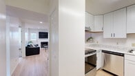 Located at 502 W Green St in Urbana, Illinois, this single-floor, 4-bedroom, 2-bathroom home offers a practical and well-appointed layout across a compact yet efficiently utilized footprint. The living room serves as the central gathering space, featuring light hardwood-style flooring, recessed lighting, a classic fireplace, and windows that allow natural light to filter in — creating a bright and welcoming atmosphere. Adjacent to the living room, the kitchen is outfitted with white shaker-style cabinetry, marble-look countertops, open shelving, and a full suite of stainless steel appliances including a range, dishwasher, and refrigerator. Light flooring continues throughout, tying the common areas together cohesively. The four bedrooms are carpeted and bright, each featuring windows with views of surrounding greenery. The bedrooms offer functional closet storage, including open-rack closet systems. Both bathrooms share a consistent design aesthetic, featuring hexagonal tile flooring and tub-shower combinations with clean white surrounds. Two hallways connect the spaces efficiently, and two dedicated closets provide additional storage. The home's clean, neutral palette and updated finishes make it a well-maintained and move-in ready residence in Urbana.
