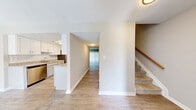 Located at 700 Heritage Ln in Bel Air, Maryland, this two-story, 3-bedroom, 3-bathroom home offers a well-designed layout spread across two evenly balanced floors. The main level features light hardwood-style flooring throughout the open living and kitchen areas. The galley-style kitchen is outfitted with white shaker cabinetry, granite-look countertops, a subway tile backsplash, and stainless steel appliances including a refrigerator, dishwasher, and range — all illuminated by overhead lighting. The living room is bright and open, featuring a ceiling fan and a large sliding glass door dressed with vertical blinds that allows natural light to fill the space. A carpeted staircase with a warm wood handrail connects the two levels. Upstairs, the bedrooms are carpeted and neutrally toned, offering a comfortable and quiet retreat. The primary bedroom includes access to a dedicated closet area with wire shelving. Bathrooms are clean and functional — one features a glass-enclosed walk-in shower with white subway tile, while another includes a full soaking tub with tile surround. Additional highlights include multiple closets for generous storage, a dedicated laundry area, and a utility room. The home's neutral palette and consistent finishes create a cohesive, move-in-ready atmosphere throughout.