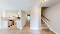 Located at 700 Heritage Ln in Bel Air, Maryland, this two-story, 3-bedroom, 3-bathroom home offers a well-designed layout spread across two evenly balanced floors. The main level features light hardwood-style flooring throughout the open living and kitchen areas. The galley-style kitchen is outfitted with white shaker cabinetry, granite-look countertops, a subway tile backsplash, and stainless steel appliances including a refrigerator, dishwasher, and range — all illuminated by overhead lighting. The living room is bright and open, featuring a ceiling fan and a large sliding glass door dressed with vertical blinds that allows natural light to fill the space. A carpeted staircase with a warm wood handrail connects the two levels. Upstairs, the bedrooms are carpeted and neutrally toned, offering a comfortable and quiet retreat. The primary bedroom includes access to a dedicated closet area with wire shelving. Bathrooms are clean and functional — one features a glass-enclosed walk-in shower with white subway tile, while another includes a full soaking tub with tile surround. Additional highlights include multiple closets for generous storage, a dedicated laundry area, and a utility room. The home's neutral palette and consistent finishes create a cohesive, move-in-ready atmosphere throughout.