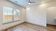 Located at 2036 Oak Grove Pkwy in Aubrey, TX, this two-story home offers a well-designed layout spread across two floors. The ground floor features an open-concept living, dining, and kitchen area filled with natural light from multiple windows. The kitchen is a standout, boasting white cabinetry, a tiled backsplash, stainless steel appliances, and a granite-topped island with a undermount sink and stylish pendant lighting. Wood-look flooring runs throughout the main level, complementing the clean, neutral palette. A staircase leads to the upper floor, where all three bedrooms are located. The primary bedroom offers generous proportions, carpet flooring, and access to a dedicated closet. The bathrooms are well-appointed, with one featuring wood-look flooring, a tub-shower combo with marble-style tile surround, and granite vanity countertops. Upstairs hallways are bright and open, with recessed lighting and ample closet storage throughout. The home also includes an attached garage and a pantry. Outside, the brick exterior is complemented by a wood-fenced yard, and the property sits within a well-maintained neighborhood community in Aubrey, TX.