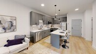 Located at 100 Mia Rose Way in Dardenne Prairie, MO, this single-floor, one-bedroom, one-bathroom residence offers a thoughtfully designed layout that maximizes comfort and functionality. The open-concept kitchen is a standout feature, showcasing floor-to-ceiling gray shaker cabinetry, a neutral subway tile backsplash, crisp white countertops, and a full suite of stainless steel appliances. A central island with bar seating and stylish pendant lighting anchors the space, flowing naturally into the living area — all tied together by warm-toned hardwood-style flooring. The bedroom is a comfortable retreat, complete with a ceiling fan, clean white walls, and a dedicated walk-in closet outfitted with wire shelving for organized storage. The bathroom features a full bathtub and shower combination adorned with large-format marble-look tile, adding a refined touch to the space. A private balcony extends the living space outdoors. Throughout the residence, recessed lighting, modern hardware, and a neutral color palette create a clean, contemporary ambiance that is both inviting and easy to personalize.