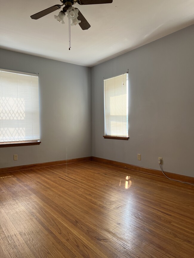 Hardwood floors, with ceiling fan, in a spacious living room - 3006 Poplar Level Rd