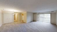 Located at 27025 Oakwood Cir in Olmsted Falls, Ohio, this single-floor, 2-bedroom, 2-bathroom residence offers a well-organized and functional layout. The open combined living and dining area is generously sized, featuring neutral-toned carpet, a textured ceiling, and large sliding glass doors fitted with vertical blinds that invite natural light and provide access to a private patio overlooking a landscaped, tree-lined community exterior. The kitchen is equipped with warm oak cabinetry, light countertops, white appliances including a gas range, dishwasher, and refrigerator, complemented by a window above the sink and durable wood-look flooring. Both bedrooms are carpeted and feature windows with vertical blinds, providing natural light and a calm, neutral atmosphere. The primary bedroom offers a comfortable footprint with ample room for furnishings. Five closets throughout the unit provide exceptional storage capacity. Each bathroom features an oak vanity with a white countertop, a lighted mirror, and clean, neutral finishes. A dedicated in-unit laundry area with shelving adds everyday convenience. The overall design is clean, practical, and move-in ready.
