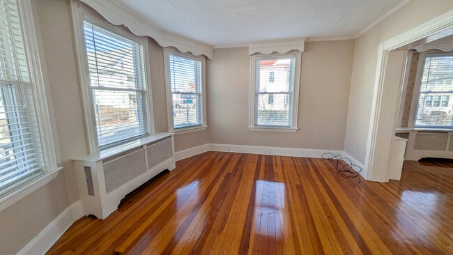 Bright and spacious living room with refinished hardwood floors and beautiful natural light - 37 Glover Ave