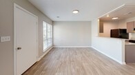 Located at 1004 Appamattox Ct in Fayetteville, NC, this single-floor, one-bedroom, one-bathroom residence offers a smart and functional layout designed to maximize every square foot. The open-concept living and kitchen area serves as the heart of the home, where light wood-look flooring flows seamlessly underfoot. The kitchen is defined by a half-wall pass-through, granite-style countertops, gray cabinetry, a double basin sink, and black stainless appliances including a refrigerator and range — all set within a galley-style configuration that keeps everything within easy reach. The living area benefits from a large window that invites natural light and outdoor views, while recessed and flush-mount ceiling lighting ensures the space is well-lit throughout. The bedroom is a comfortable retreat featuring plush wall-to-wall carpeting, a ceiling fan with light fixture, natural light from a generous window, and multiple closets providing ample storage. The bathroom includes a full soaking tub and shower combination with chrome fixtures and safety grab bar. Additional practical features include a dedicated laundry area, utility room, and multiple closets throughout. Neutral wall tones and clean white trim give the entire residence a fresh, move-in-ready feel.