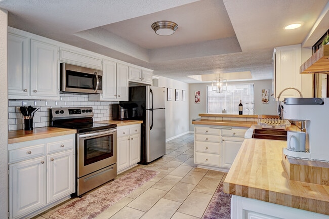 Fully equipped kitchen that includes an air fryer and coffee station. - 3905 NW 70th St