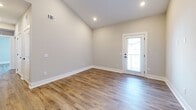 Located at 723 W 19th St in Panama City, Florida, this thoughtfully designed single-story home offers three bedrooms and two bathrooms across a well-utilized floor plan. Warm wood-look flooring flows consistently throughout every room, complementing the neutral gray walls and clean white trim that define the home's modern aesthetic.

The kitchen serves as a focal point, showcasing white shaker-style cabinetry with matte black hardware, a vibrant blue shiplap island with a white quartz countertop and undermount sink, a subway tile backsplash in coordinating blue tones, and stainless steel appliances. Vaulted ceilings above the kitchen amplify the sense of openness in this shared living area.

The bedrooms are bright and airy, with multiple windows dressed in blinds allowing ample natural light. The primary bedroom features a dedicated walk-in closet, while the additional bedrooms offer comfortable, versatile spaces. A closet with built-in cabinetry provides extra storage throughout the home.

The bathrooms are finished in a clean, contemporary style with white vanities, quartz countertops, matte black fixtures, and tile-surround showers. The overall ambiance of the home is fresh and move-in ready, reflecting a cohesive modern design with practical, quality finishes throughout.