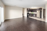 Located at 180 Mill St in London, Ontario, this well-appointed unit offers three bedrooms, four bathrooms, and a thoughtfully designed single-floor layout that makes excellent use of its generous square footage. The open-concept kitchen and living area form the heart of the unit, showcasing rich dark-stained cabinetry, granite countertops with a double sink, stainless steel appliances including a refrigerator, electric range, and dishwasher, and light ceramic tile flooring that transitions into warm hardwood throughout the main living spaces. The living room is bright and spacious, benefiting from large windows and sliding glass doors that open to a private balcony with outdoor views. Each bedroom is well-sized, with the primary bedroom offering ample space, and the secondary bedrooms featuring sliding-door closets and hardwood flooring. The four bathrooms include clean, functional finishes with a tub-shower combination. A dedicated laundry room houses a stacked washer and dryer alongside the building's mechanical systems for added convenience. Warm beige tones, textured ceilings, and consistent hardwood flooring throughout create a cohesive and comfortable ambiance across the entire unit.