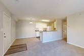 Located at 13671 Cridercrest Place in Woodbridge, VA, this single-floor, 3-bedroom, 2-bathroom home offers a practical and comfortable layout. The open-concept living and dining area features neutral-toned carpet, a textured ceiling, and a pendant light fixture, creating a bright and welcoming atmosphere. The kitchen is well-appointed with white cabinetry, dark granite-style countertops, a full suite of white appliances including a range and refrigerator, and wood-look flooring. A peninsula counter connects the kitchen to the living area, enhancing the open flow of the space. The bedrooms are carpeted and filled with natural light from windows fitted with horizontal blinds, offering pleasant outdoor views. Two full bathrooms feature white vanity cabinetry, dark countertops, and lighted mirrors. A dedicated in-unit laundry room houses a full-size washer and dryer. Five closets throughout the home provide generous storage, while a utility room adds further functionality. A private patio rounds out the home, offering an outdoor retreat. With a well-connected hallway tying all rooms together, this home delivers efficient, comfortable single-level living.