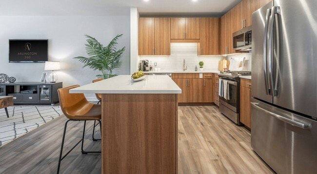 Cabinets run to the ceiling on the range wall, with the island facing out. - Arlington 360