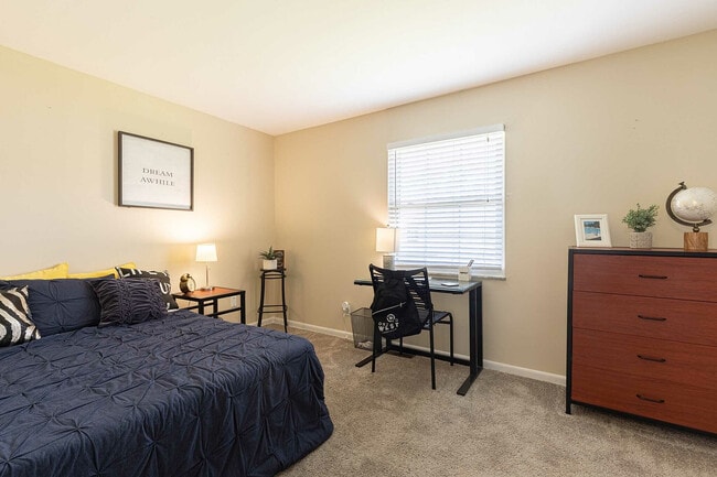Experience comfort and functionality in this beautifully designed bedroom. - Oxford West Apartments