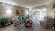 Located at 401 W Orangewood Ave in Anaheim, California, this single-story residence offers a well-appointed layout designed for comfortable everyday living. The living room serves as the heart of the home, featuring plush carpeting, neutral warm-toned walls, and a sliding glass door that opens directly onto a private patio, filling the space with natural light. The dining area features hardwood-style flooring, large wall art, and a mirrored accent wall that enhances the sense of space.

The galley-style kitchen is efficiently designed with warm wood cabinetry, granite-style countertops, a double-basin sink, and hardwood-style flooring. It is fully equipped with a full appliance suite including a range, refrigerator, microwave, and dishwasher.

The spacious primary bedroom is carpeted and features large windows that invite natural light, with ample room for a seating area. A second bedroom offers similar comfort with soft carpeting and warm accent walls. The primary bathroom includes a wide vanity with granite-style countertops, hardwood-style flooring, and access to a generous walk-in closet. The full bathroom features a soaking tub and shower combination with clean subway-style tile surround in a soft sage tone.