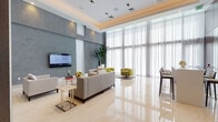 Located at 990 NW Seventh Street in Miami's Health District, this elegantly designed amenity floor presents a seamless blend of modern architecture and refined interior finishes throughout its single level. Polished marble-look tile flooring runs continuously across the entire space, reflecting light and enhancing the sense of openness.

The formal dining area commands attention with dramatic oversized circular pendant fixtures suspended from a coffered ceiling, set against deep charcoal wall panels and sheer floor-to-ceiling drapery that diffuses natural light. Multiple dining tables and upholstered chairs accommodate a generous number of guests in a restaurant-quality setting.

A spacious lounge area features a neutral palette highlighted by warm wood-toned ceiling accents, floor-to-ceiling sheer curtains, and a wall-mounted flat-screen television. Plush seating arrangements in cream and chartreuse tones create inviting conversation areas.

The reception corridor showcases rich dark wood-paneled walls and a substantial built-in millwork desk with large mirror accents, conveying a professional and polished welcome. Adjacent to this is a private office nook enclosed by glass partitions with views to the outdoors.

A wet bar area with marble countertops, dark wood cabinetry, and illuminated open shelving provides a stylish entertaining hub. The game room rounds out the amenities with a dedicated poker table, contemporary artwork, and a billiards area.