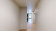 Located at 355 E 5th Ave in Eugene, Oregon, this thoughtfully designed unit offers a well-organized layout across a single floor, comprising a living room, kitchen, bathroom, and hallway. Light wood-tone flooring runs consistently throughout, creating a clean, cohesive aesthetic that enhances the sense of openness.

The living area features neutral white walls and benefits from generous natural light through large windows and a sliding glass door that opens to a balcony, providing views of the surrounding neighborhood. The bright, airy atmosphere makes the space feel welcoming and functional.

The kitchen is outfitted with modern finishes, including flat-front upper cabinetry in a warm wood tone paired with slate-blue lower cabinets. Quartz countertops and a subway tile backsplash add a polished look, while stainless steel appliances — including a range and over-the-range microwave — and a stainless steel sink complete the contemporary setup. The hallway connects the living and kitchen areas to the entry door, maintaining an efficient flow throughout.

The bathroom features a quartz-topped vanity with navy cabinetry, under-cabinet accent lighting, a framed mirror, and a full tub-shower combination with a clean white surround. Recessed lighting adds a refined touch. Overall, the unit presents a modern, move-in-ready interior with quality finishes and a practical, well-proportioned design.