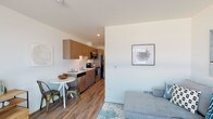 Located at 429 2nd Avenue West in Seattle's desirable Queen Anne neighborhood, this thoughtfully designed single-floor residence offers a cohesive open-concept layout that maximizes functionality and flow. Warm wood-tone luxury vinyl plank flooring runs throughout the entire space, tying each area together with a consistent modern aesthetic.

The kitchen is efficiently designed with flat-front wood cabinetry, a stainless steel refrigerator, stove, and built-in microwave, complemented by a clean white countertop and undermount sink. A compact dining area sits adjacent to the kitchen, offering a natural transition into the living space.

The living area provides a comfortable, well-proportioned space with clean white walls that allow for flexible furnishing arrangements. Recessed lighting and a neutral color palette enhance the bright, airy atmosphere of the open living and dining zones.

The bedroom is a quiet, well-defined retreat featuring the same warm flooring, soft lighting, and ample wall space. It is separated from the main living area, providing privacy and a restful environment.

The bathroom maintains the design language of the rest of the unit, featuring a wood-fronted vanity with a white countertop, a large mirror, and wood-look flooring, creating a clean and cohesive finish. Overall, this residence delivers a modern, functional living experience in one of Seattle's most vibrant neighborhoods.